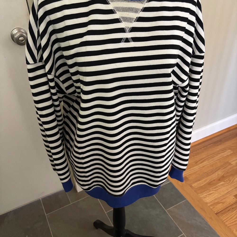 Black and white striped sweatshirt with royal blue trim